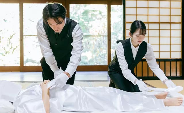 町田市家族葬 東横メモリアルのスタッフが和室で故人を丁寧に安置する様子